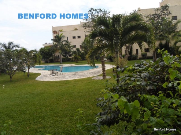 Lush lawn swimming pool and mature trees paving to a 4 bedroom executive apartment| Benford Homes