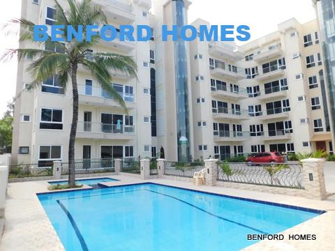 A modern residential building with a large pool, reflecting the luxury and comfort of the Benford Homes Nyali apartment