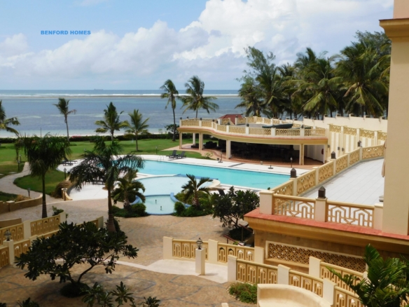 Huge balcony with a swimming pool and tree lining on the edge glancing panoramic blue ocean