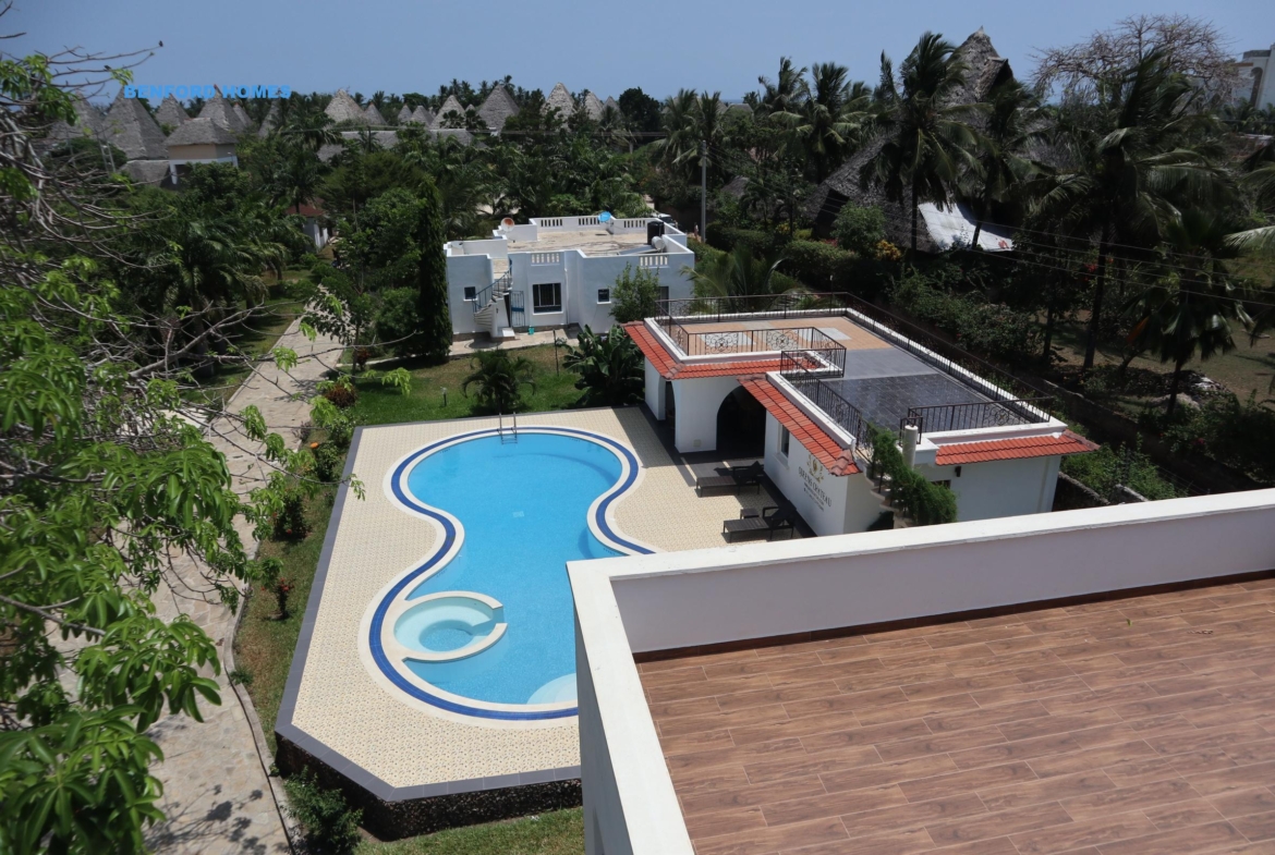 Elevated view of a six bedroom lavish apartment with a swimming pool in a tree lined villa| Benford Homes