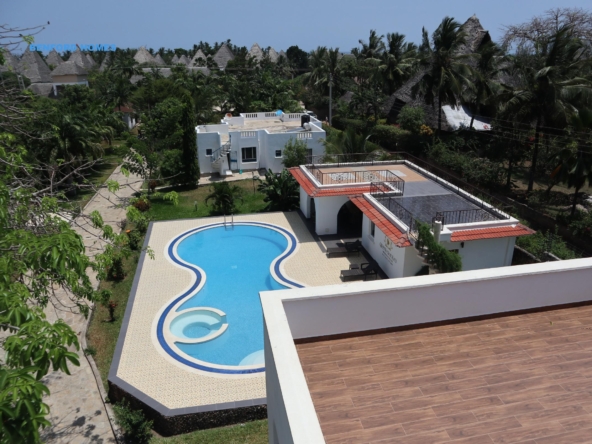 Elevated view of a six bedroom lavish apartment with a swimming pool in a tree lined villa| Benford Homes