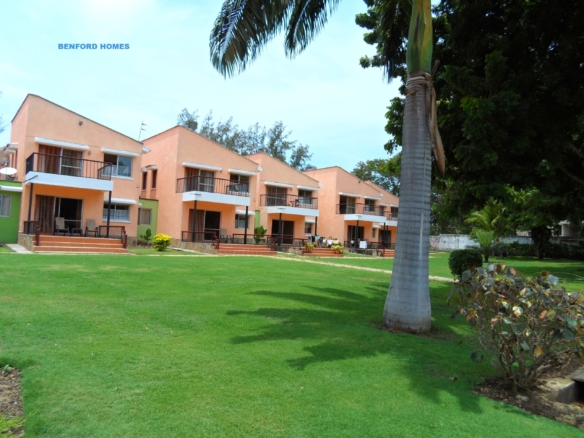 Green lush lawn and trees lined in the compound of a modern lavish resort
