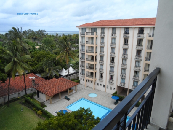 A luxurious 2-bedroom Benford Homes apartment, highlighting its modern design and breathtaking sea views. The lush surroundings and proximity to amenities enhance its appeal, making it a prime property on the North coast.