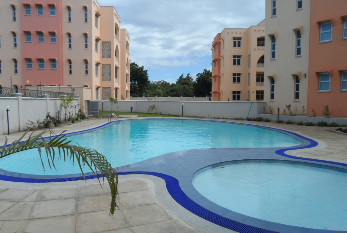 Marseille shaped pool with 2 bedroom apartments standing near the pool | Benford Apartments for Rent in Mtwapa